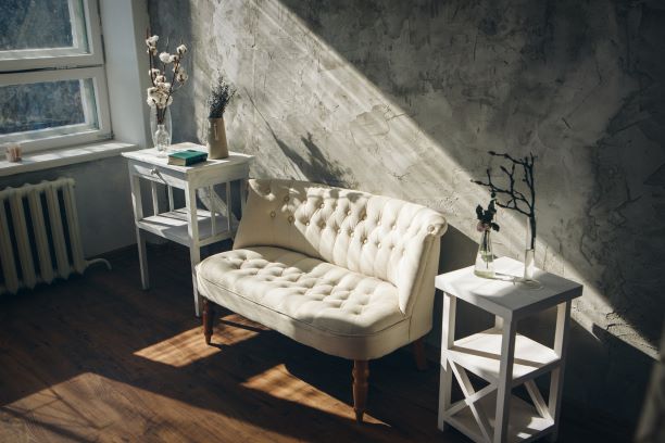 white couch beside the window