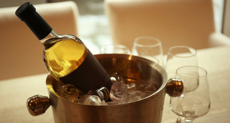 A wine bottle in a bucket of ice