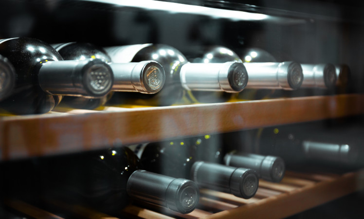 Wine bottles inside a wine fridge