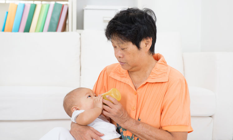 Domestic helper caring for an infant