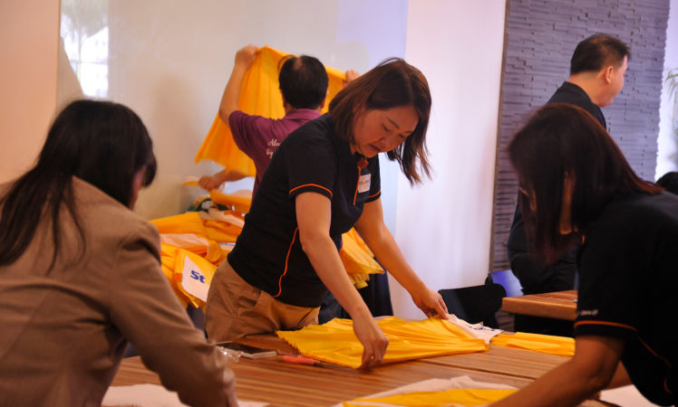 dismantled the old umbrellas from their metal frames and cut fabric patterns ready to be sewn into bags