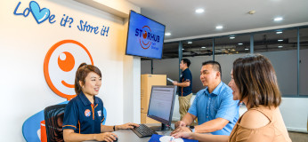 Storage specialist and customers in StorHub reception area